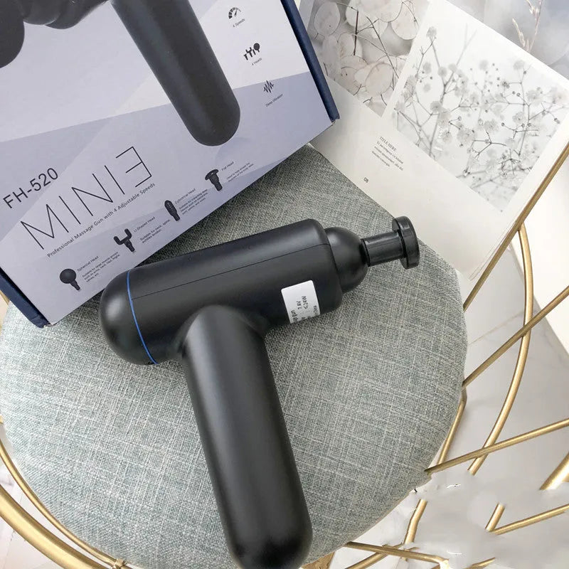 Grey fascia gun muscle massager with USB charging port for percussive therapy