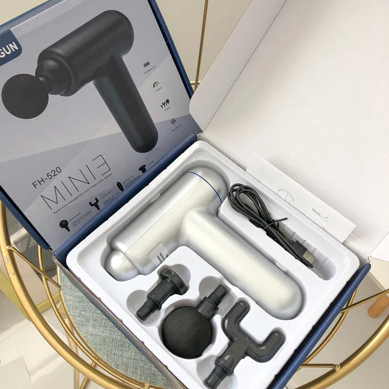 Grey fascia gun muscle massager with USB charging port for percussive therapy