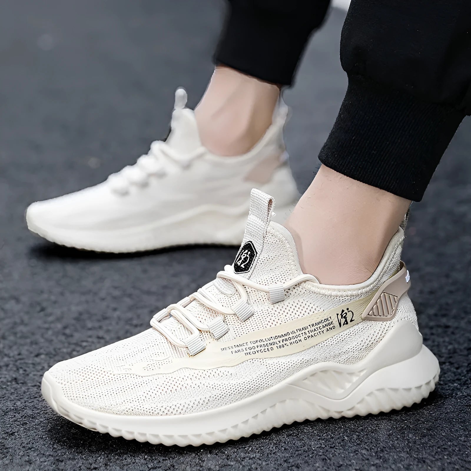 Men's white mesh sports shoes with rubber soles and front tie closure on neutral background