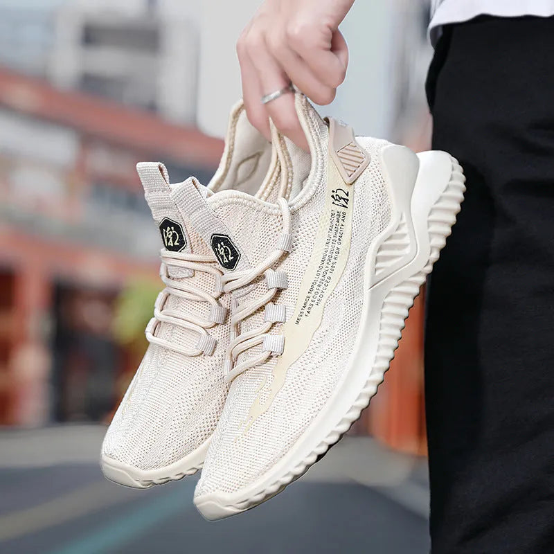 Men's white mesh sports shoes with rubber soles and front tie closure on neutral background