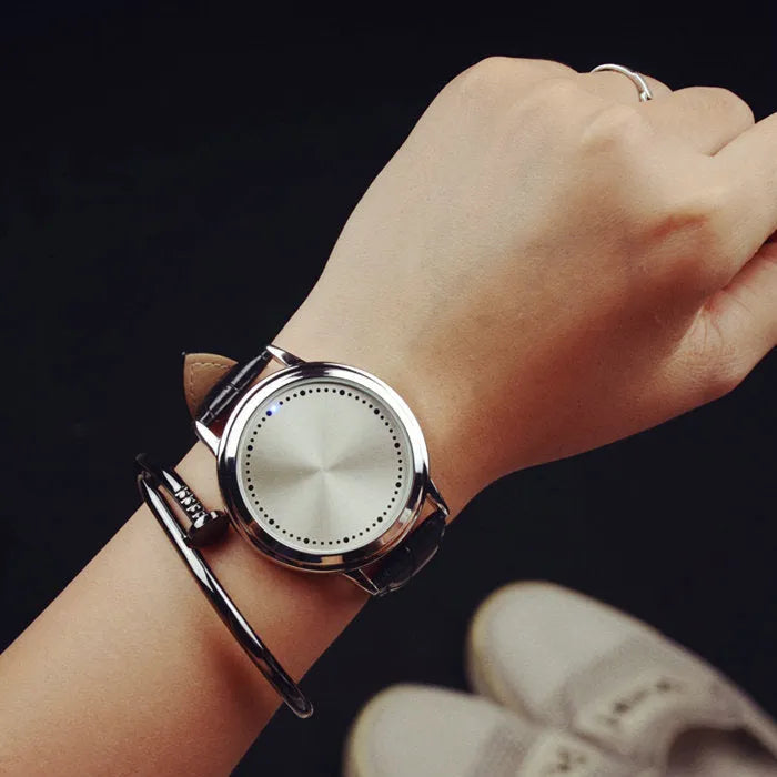 Electronic digital watch with blue light display showing numbers in black or white casing