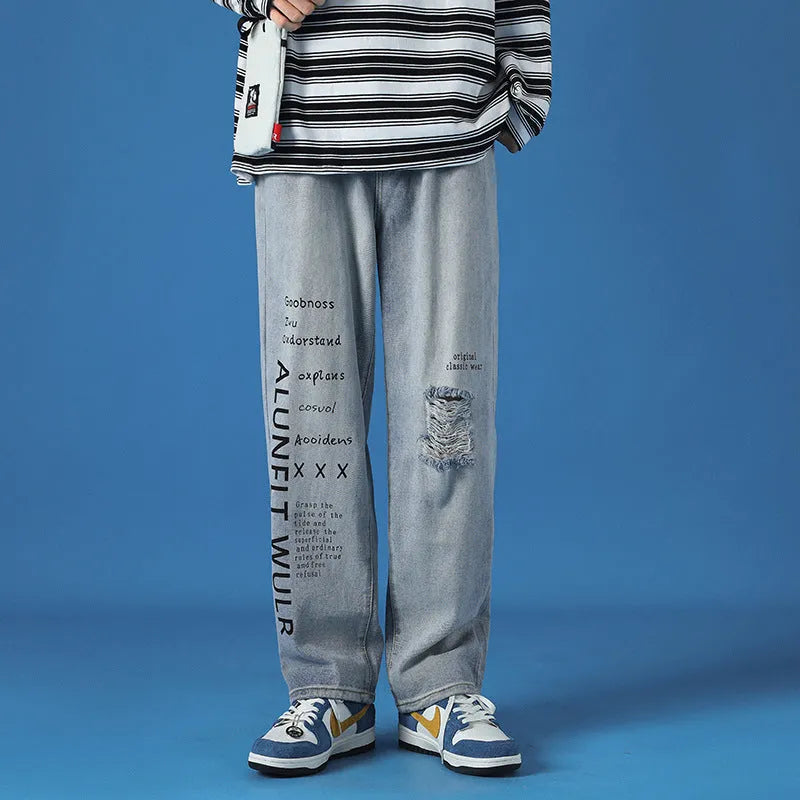 Men's loose fit washed cotton jeans in light blue with printed design and zipper fly, available in sizes M to 5XL