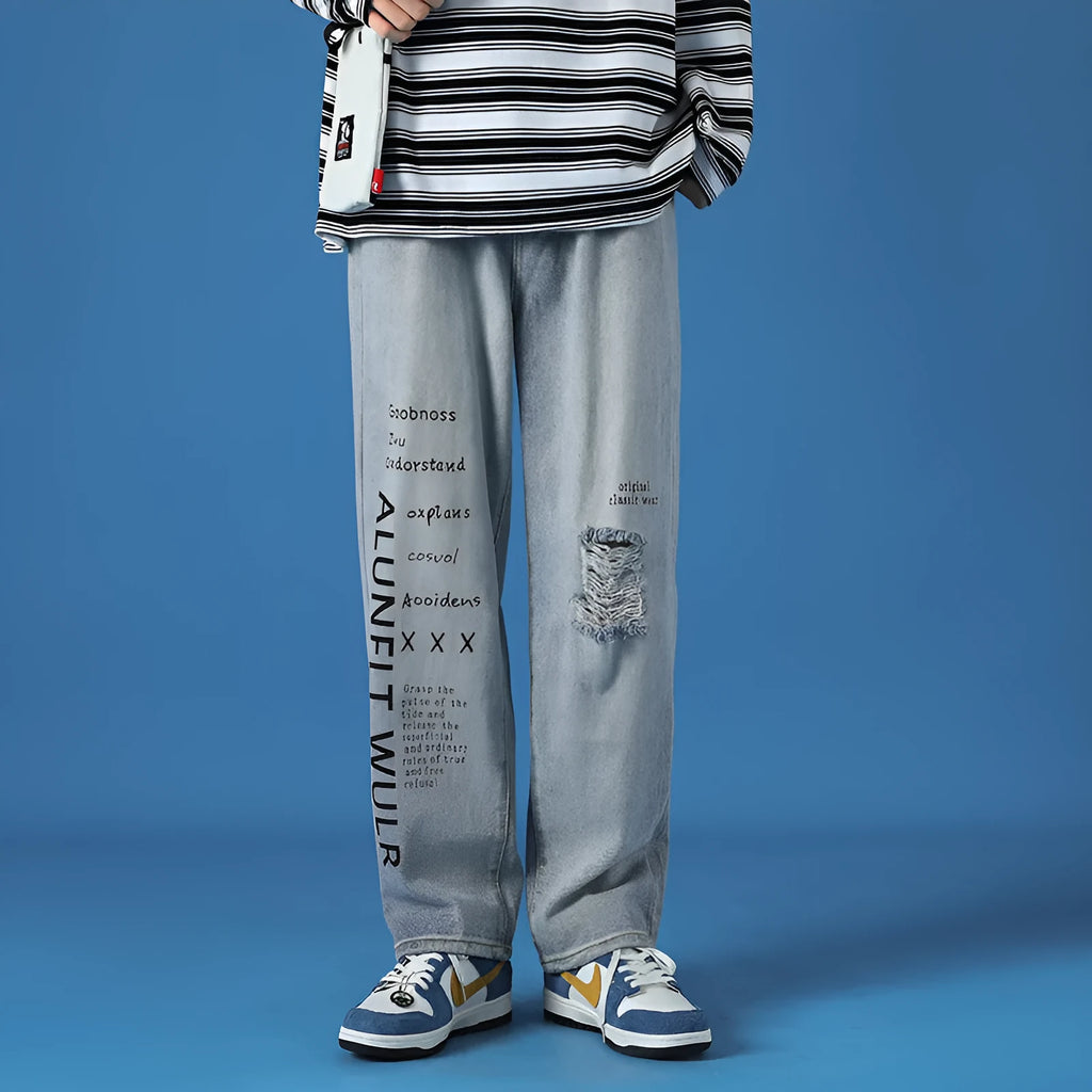 Men's loose fit washed cotton jeans in light blue with printed design and zipper fly, available in sizes M to 5XL