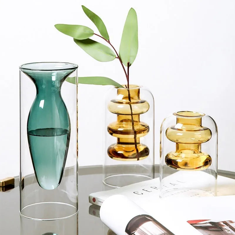 Colourful double layer blown glass vase in pink tone on a dining table with dried flowers