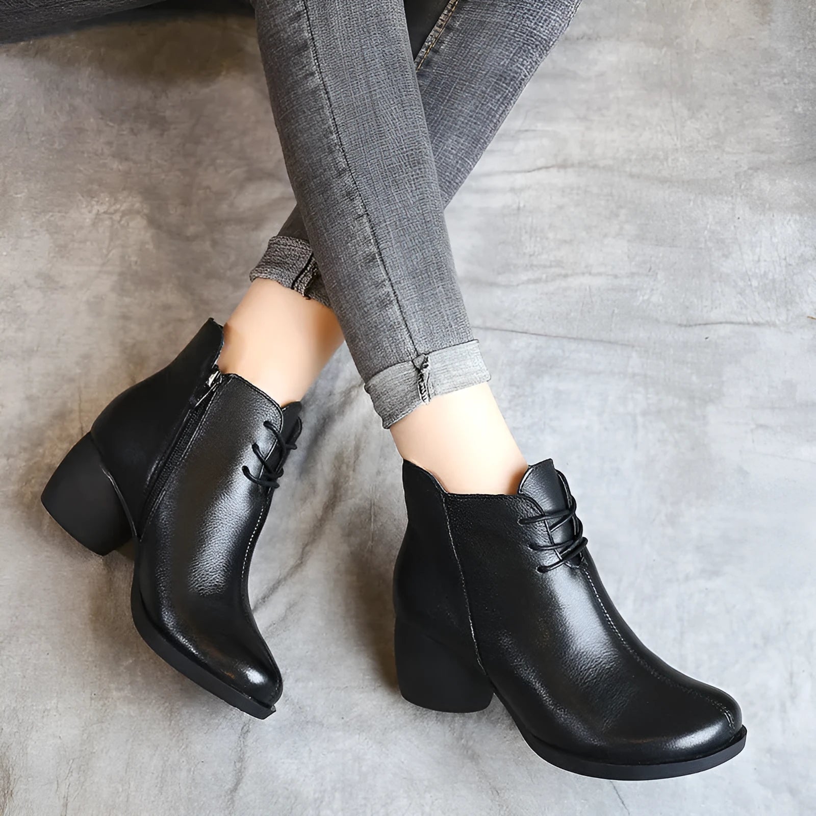 Women's black leather Martin ankle boots with a thick rubber heel and round toe.
