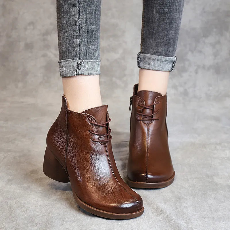Women's black leather Martin ankle boots with a thick rubber heel and round toe.