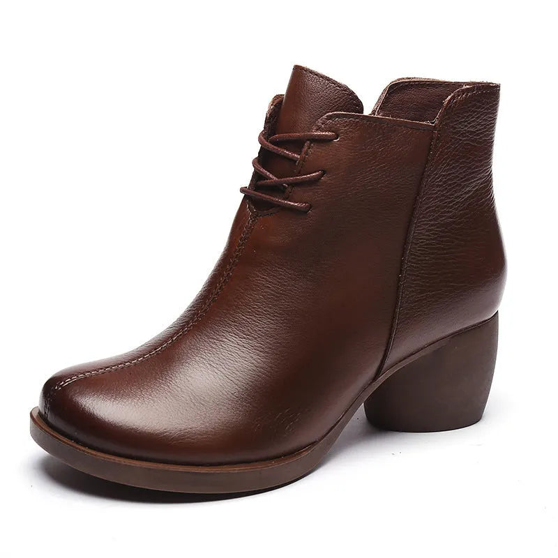 Women's black leather Martin ankle boots with a thick rubber heel and round toe.
