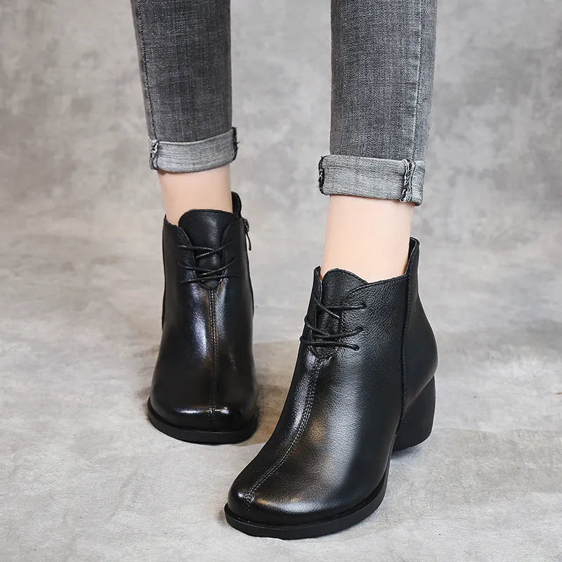 Women's black leather Martin ankle boots with a thick rubber heel and round toe.