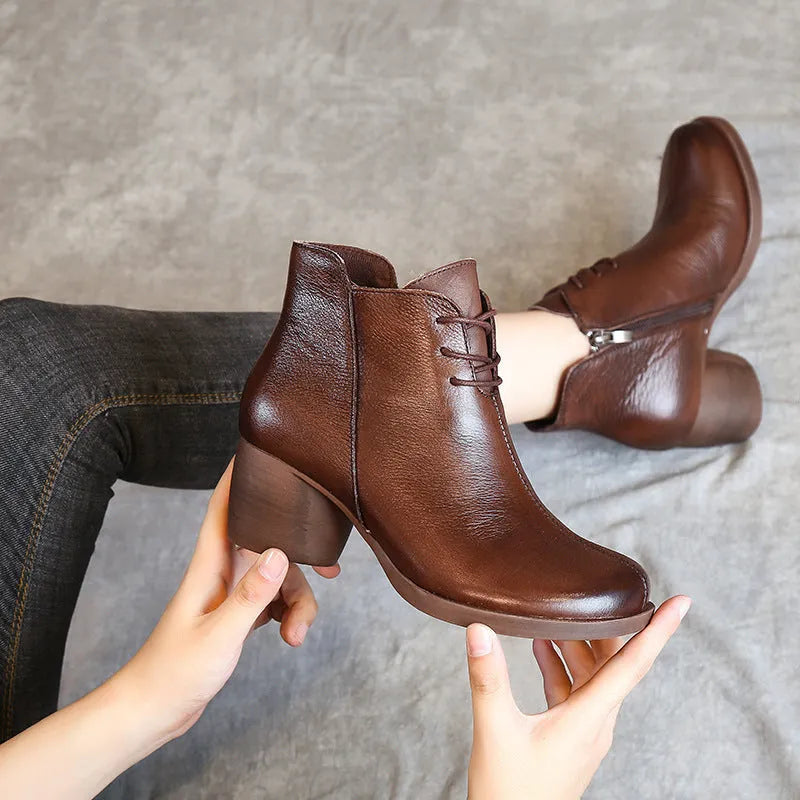 Women's black leather Martin ankle boots with a thick rubber heel and round toe.