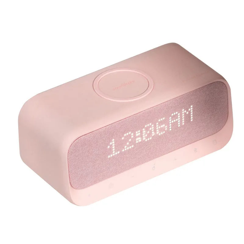 Pink and white Bluetooth speaker with wireless charging pad and alarm clock display