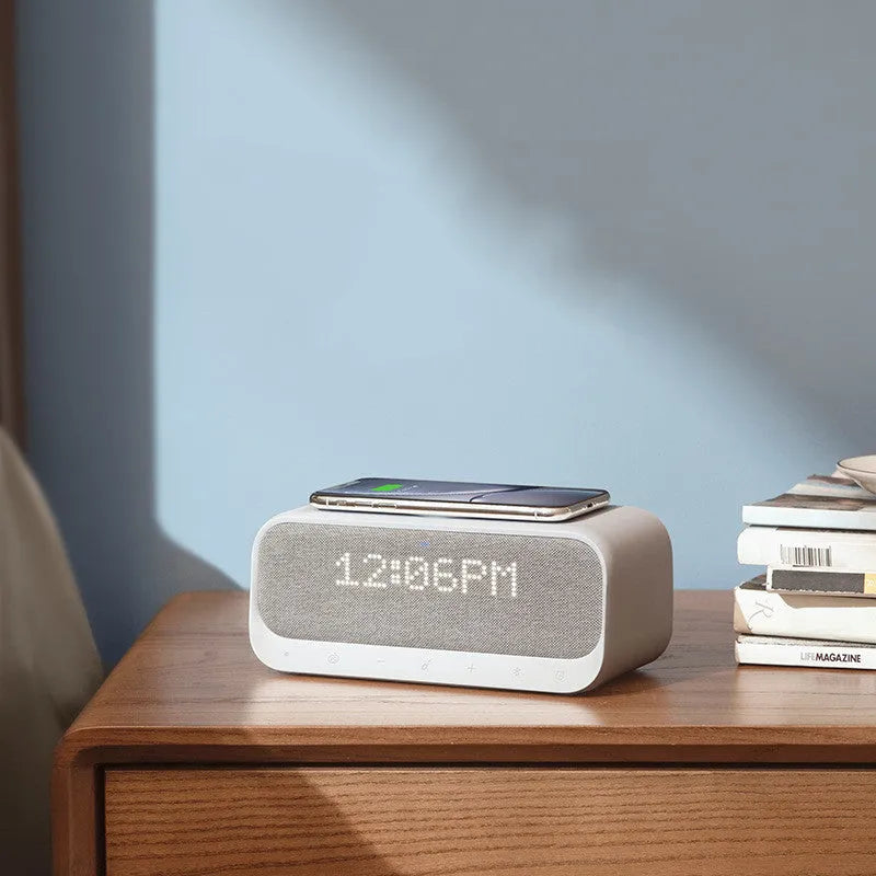 Pink and white Bluetooth speaker with wireless charging pad and alarm clock display