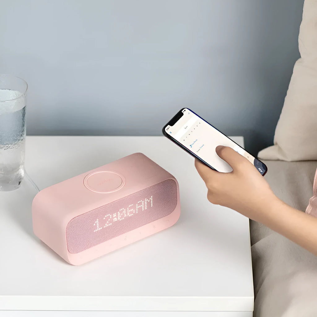 Pink and white Bluetooth speaker with wireless charging pad and alarm clock display