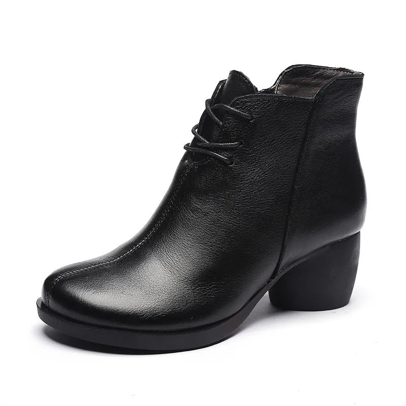 Women's black leather Martin ankle boots with a thick rubber heel and round toe.