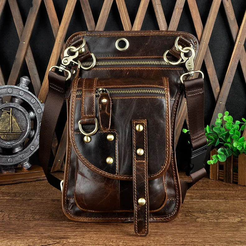 Small black genuine leather men's punk-style fanny pack worn on waist with zipper open