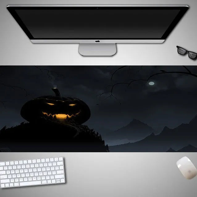 Large Halloween-themed computer mouse pad with graphic design on a desk