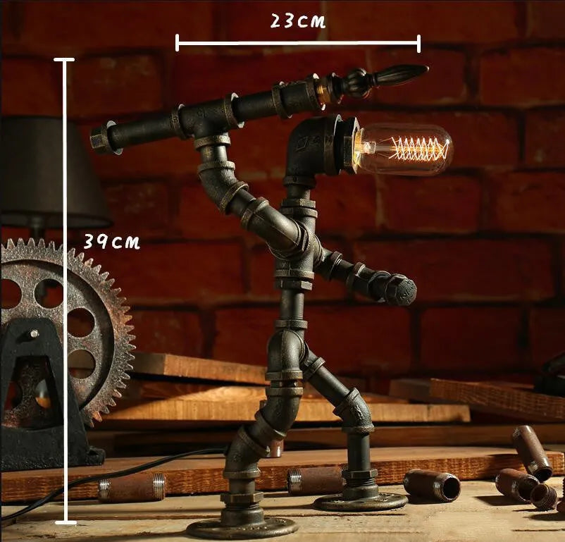 Green bronze vintage robot table lamp with industrial iron pipe design on wooden desk