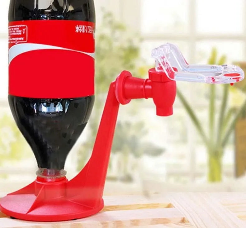 Red plastic Magic Tap soda dispenser attached to an inverted 2-litre bottle for serving fizzy drinks