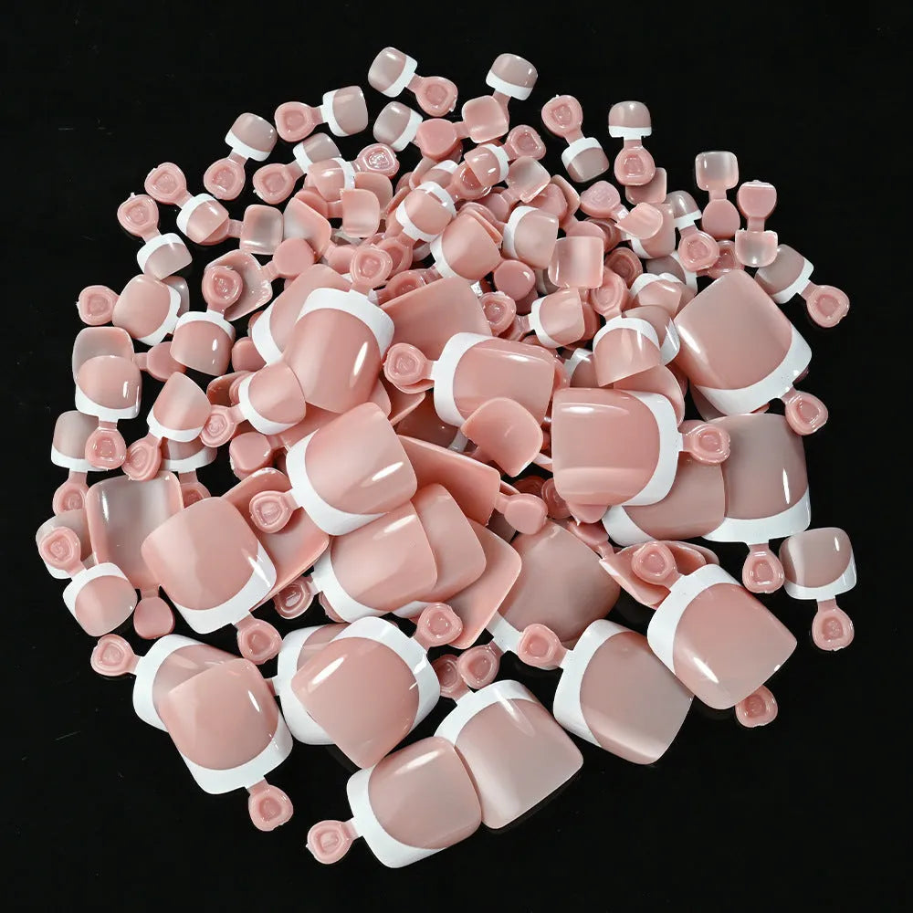 Box of 120 French white edge press-on toe nails in full square short shape showing multiple nude shades.