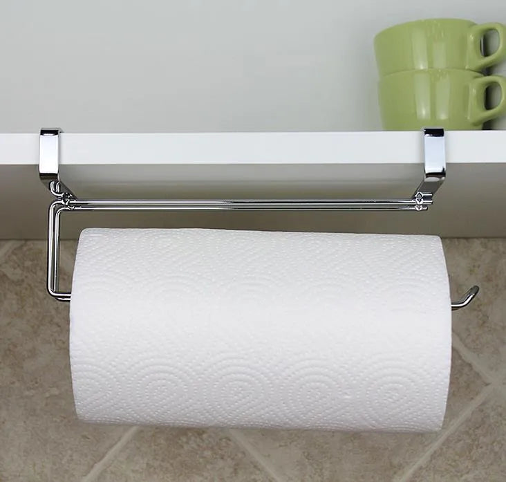 Silver stainless steel paper towel rack mounted on a white cabinet door.