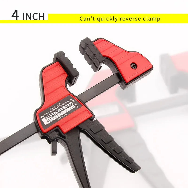 Black plastic woodworking clamp with quick release mechanism and rubber grip jaws