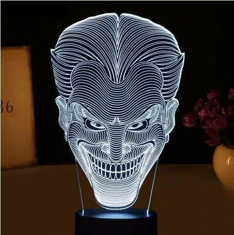 USB-powered 3D acrylic LED table lamp showing seven colour options on a desk