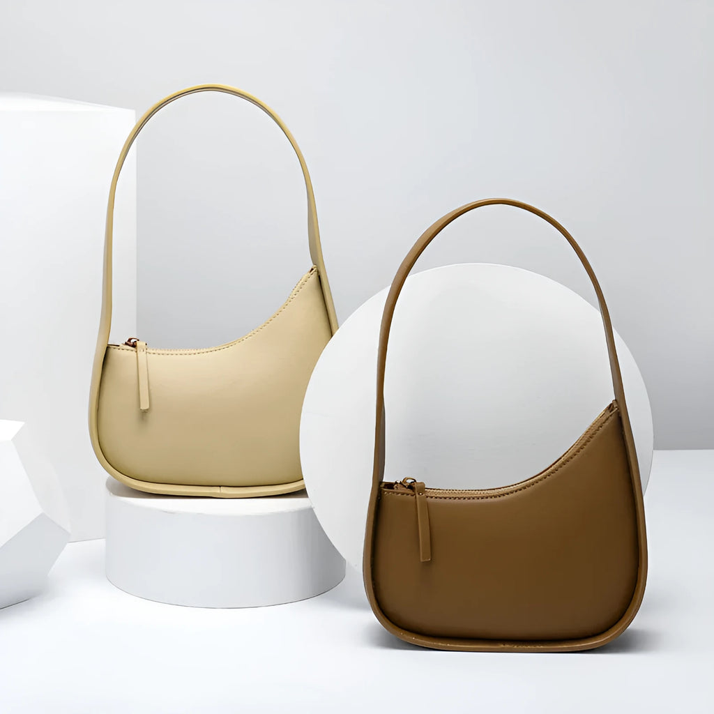 Genuine leather half moon ladies shoulder bag with wide strap and zipper closure in small size