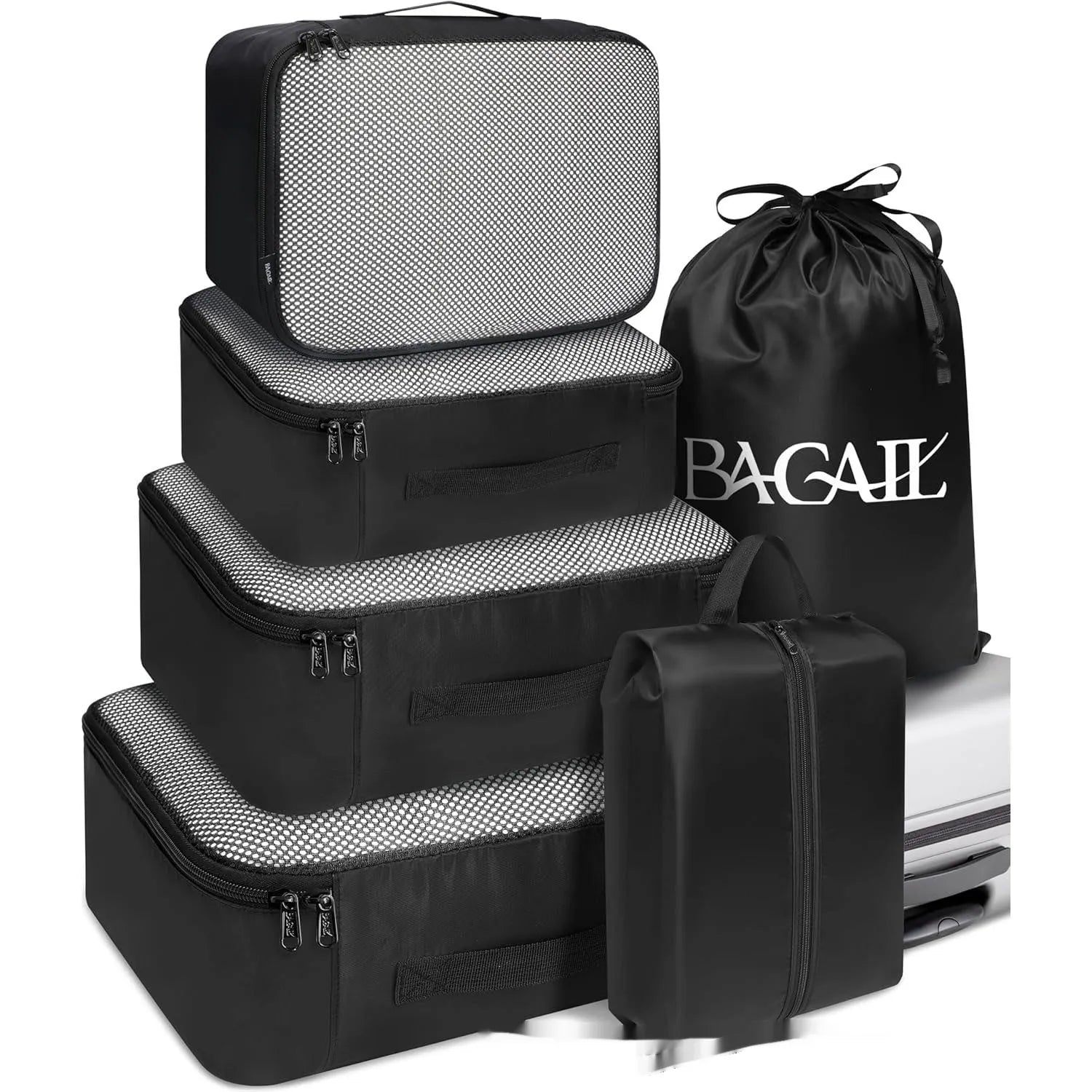 Set of eight PP packing cubes in various colours including beige, black, pink, and leopard print for travel organisation.