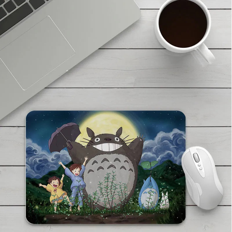 Custom cartoon thickening mouse pad on a desk, showing a colourful design with black stitched edge.