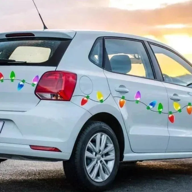 Set of magnetic reflective Christmas light bulb and wire stickers on a metal surface.