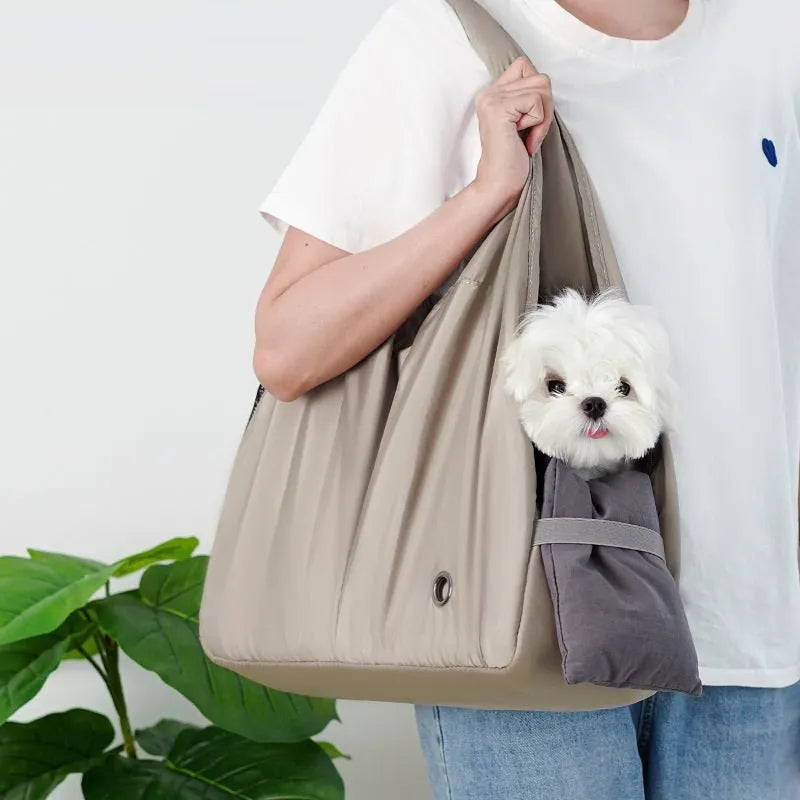 Apricot coloured cloth pet handbag carrier with dimensions 41 cm by 16 cm by 28 cm.