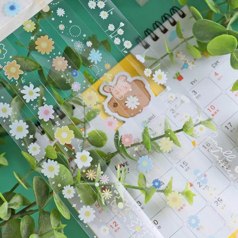 Five rolls of transparent adhesive tape with Midsummer Daisy cartoon decoration on a clear background.