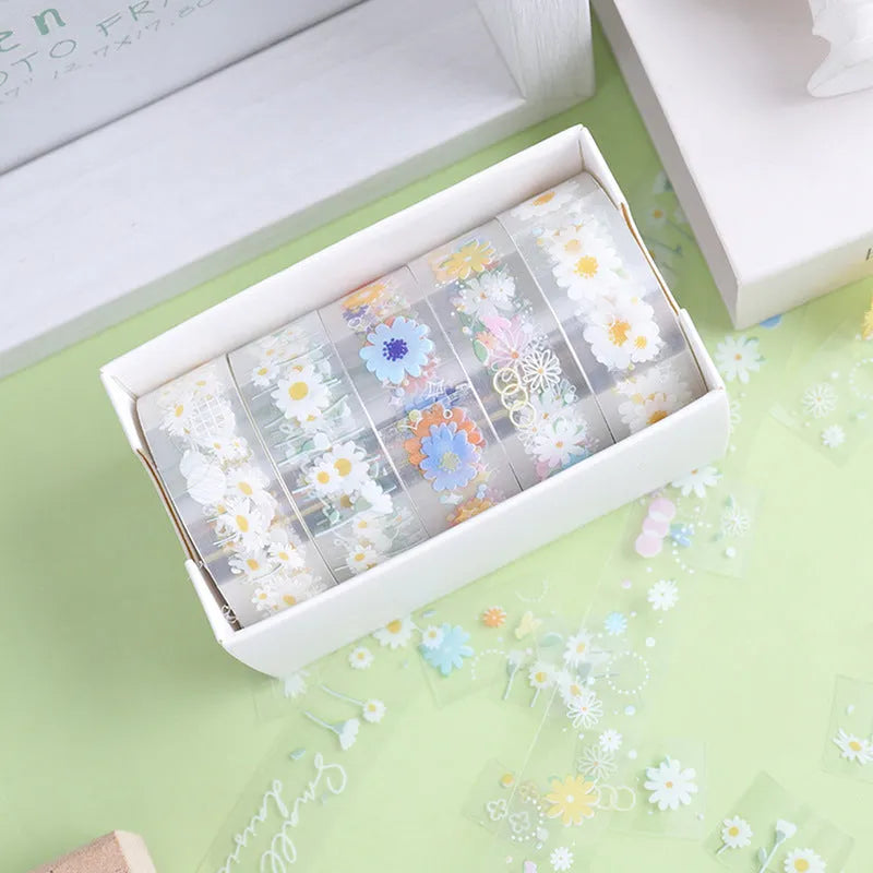 Five rolls of transparent adhesive tape with Midsummer Daisy cartoon decoration on a clear background.