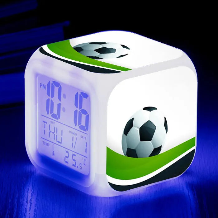 Square plastic alarm clock with a cartoon football pattern, showing silent vibrating alarm models.