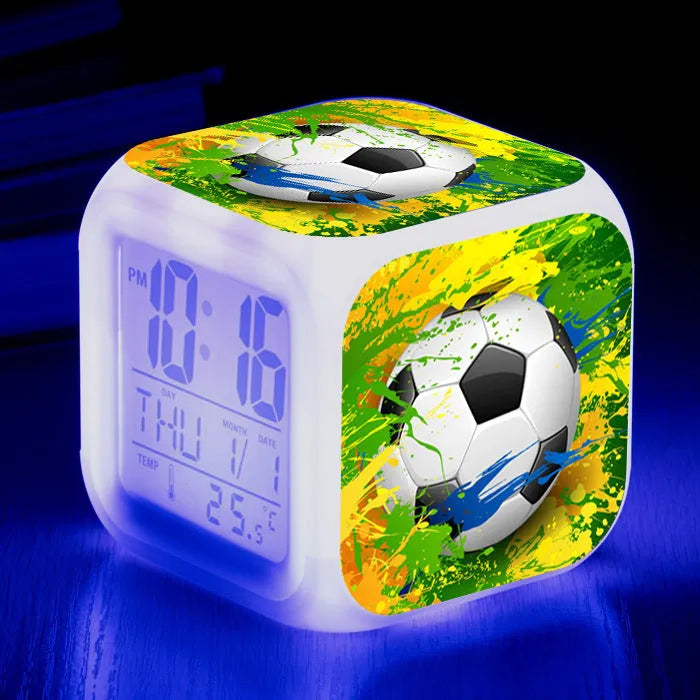 Square plastic alarm clock with a cartoon football pattern, showing silent vibrating alarm models.