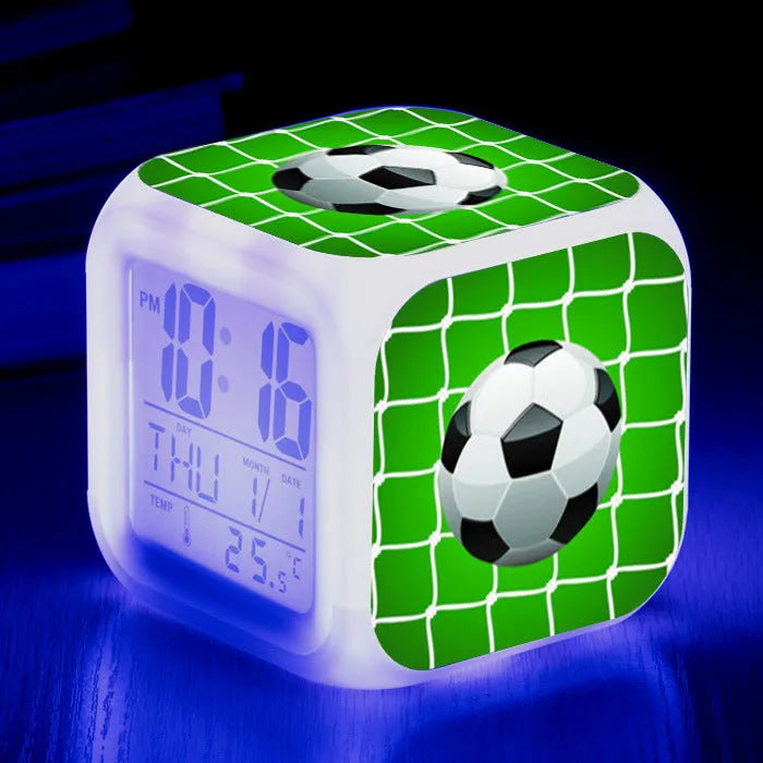 Square plastic alarm clock with a cartoon football pattern, showing silent vibrating alarm models.