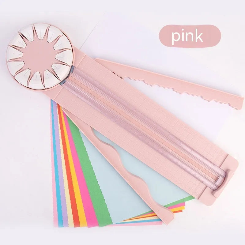 Pink and black plastic paper cutting machine with 12 patterns on desktop