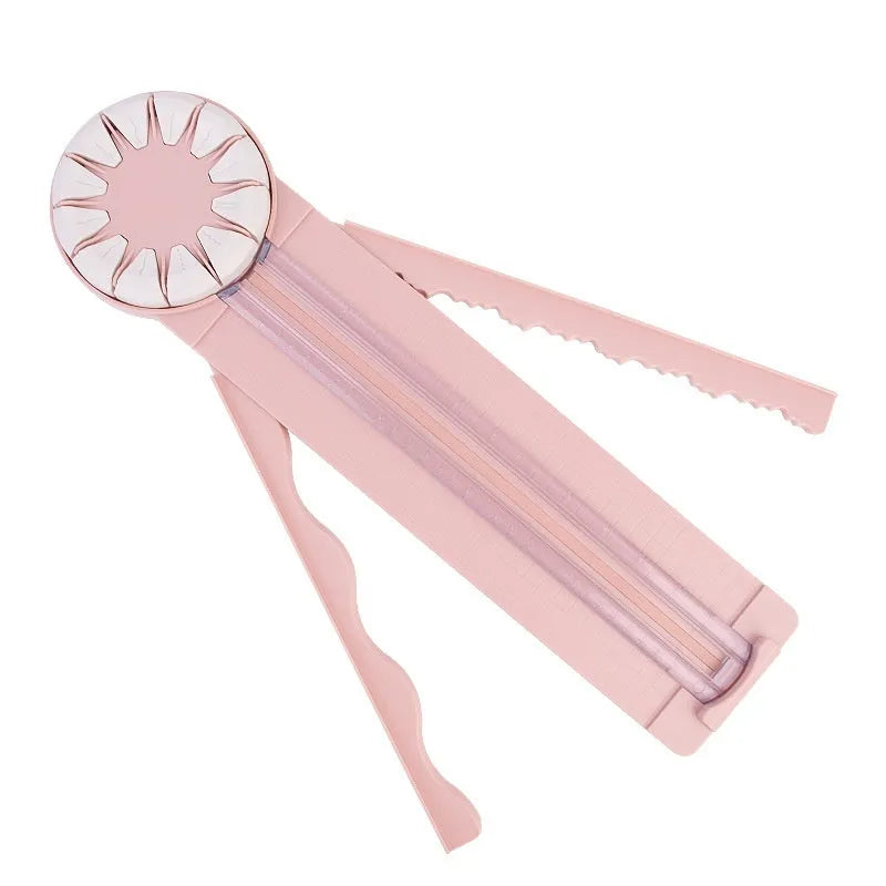 Pink and black plastic paper cutting machine with 12 patterns on desktop