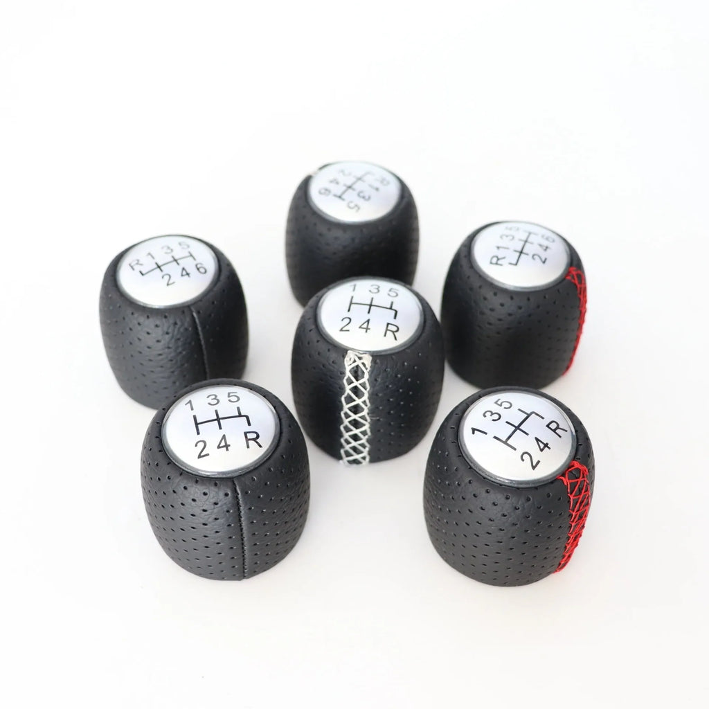 Black leather handball gear with perforations for Alpha car, shown with silver and matte cover options.