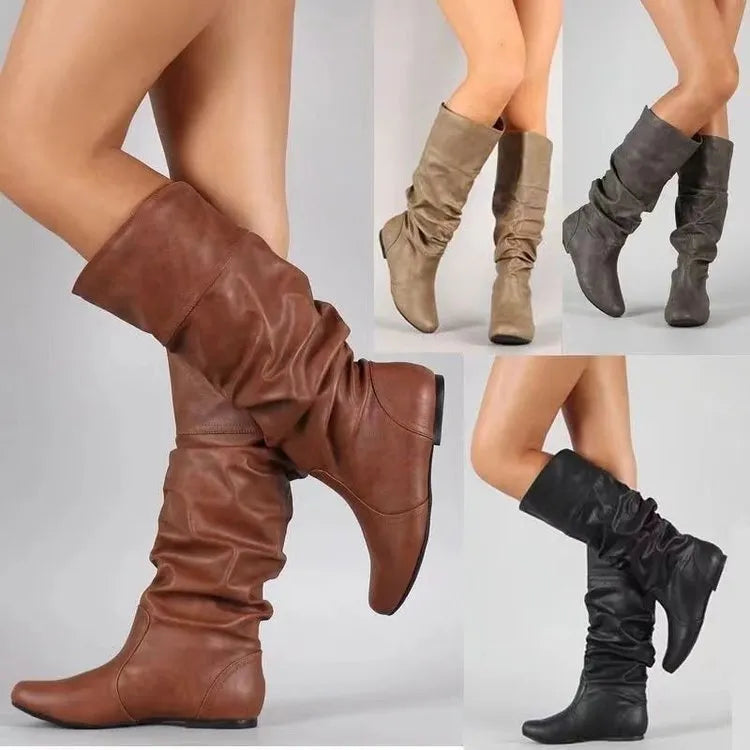 Women's black slip-on flat ankle boots with round toe and rubber sole.