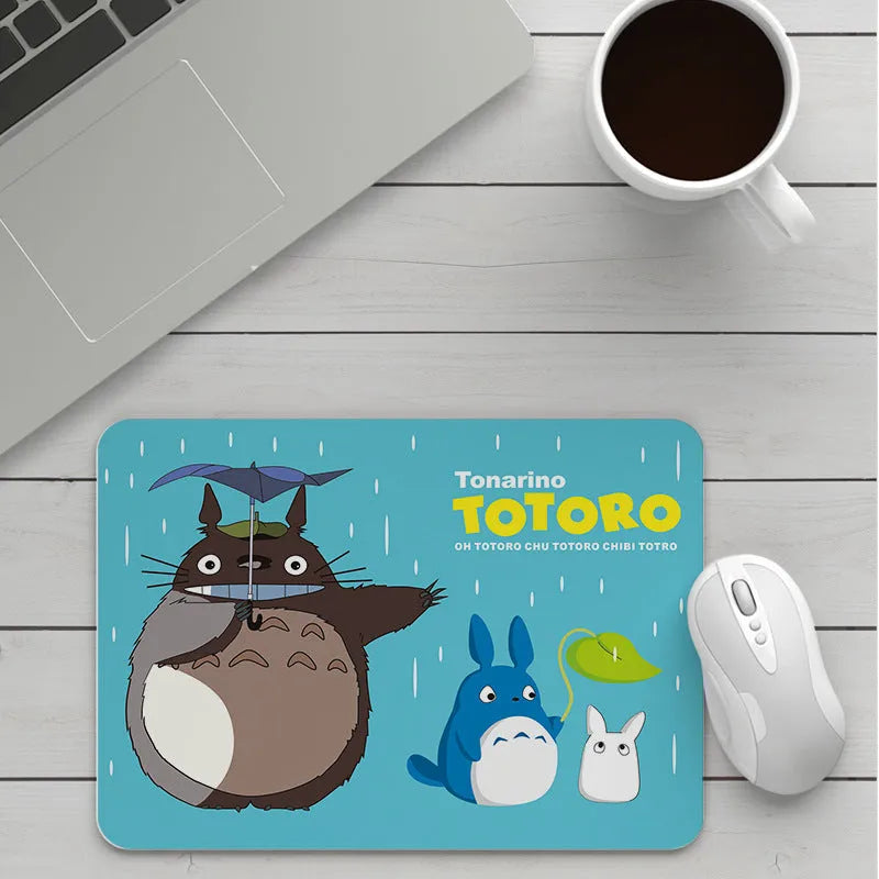 Custom cartoon thickening mouse pad on a desk, showing a colourful design with black stitched edge.
