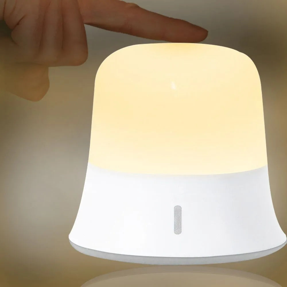 White bedside night light with touch controls, motion sensor, and rechargeable battery for nursery use.
