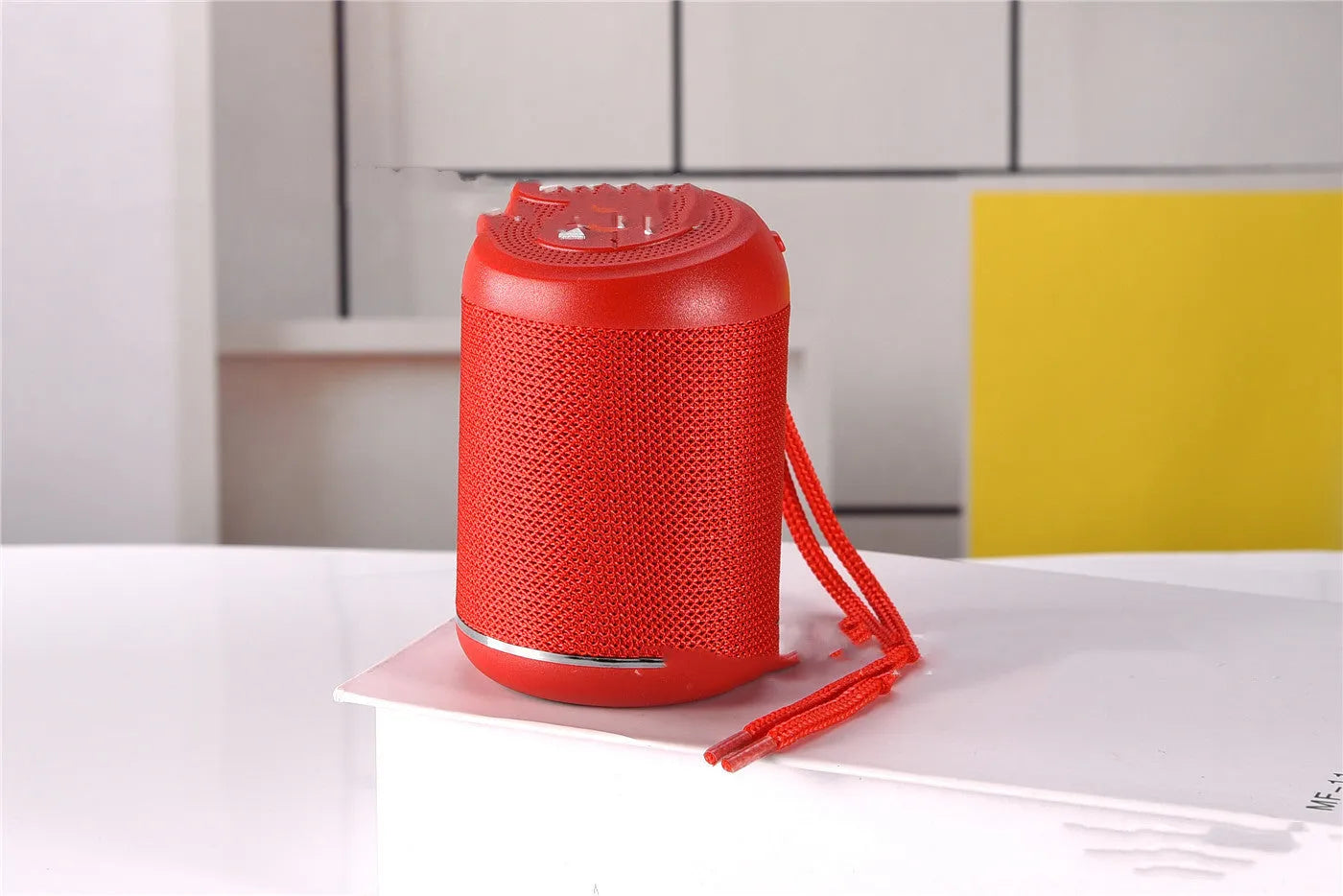 Portable outdoor Bluetooth subwoofer in black with button controls for radio, calls, and playback modes