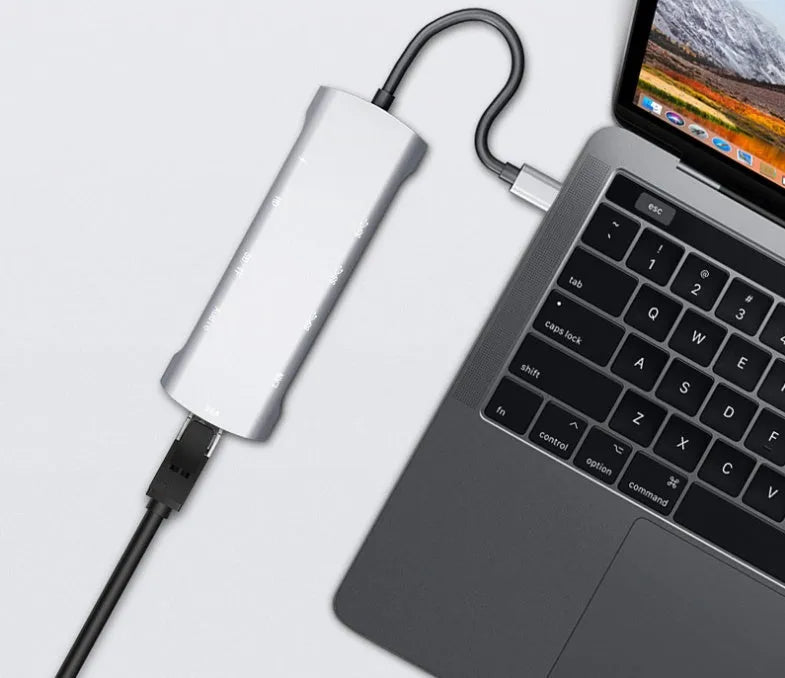 Grey USB-C docking station with HDMI, VGA, and USB 3.0 ports on aluminium alloy body