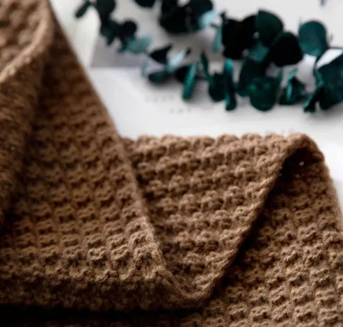 Nordic fringe knit ball blanket in beige colour on sofa, showing 130×170cm dimensions and fringe detailing.