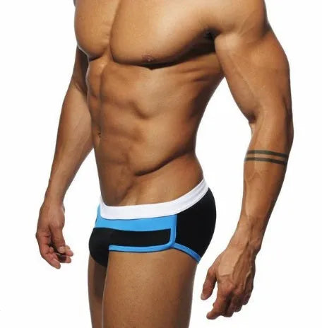 Men's nylon patchwork swim trunks in black, dark blue, and pink, available in sizes M to XXL