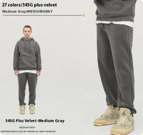 Men's dark brown velvet sweatpants with elastic waistband and banded ankle cuffs on hanger