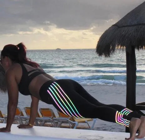 Women's black and white glow-in-the-dark workout leggings with slim-fit design