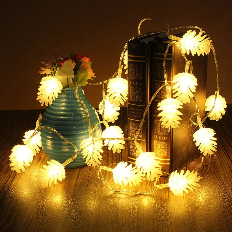 Battery-powered warm white LED pine cone light string with plastic shells, shown in 10 or 20 light options.