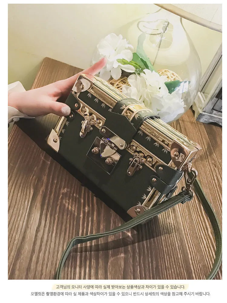 Black PU hard-sided women's shoulder bag with flap closure and decorative rivets