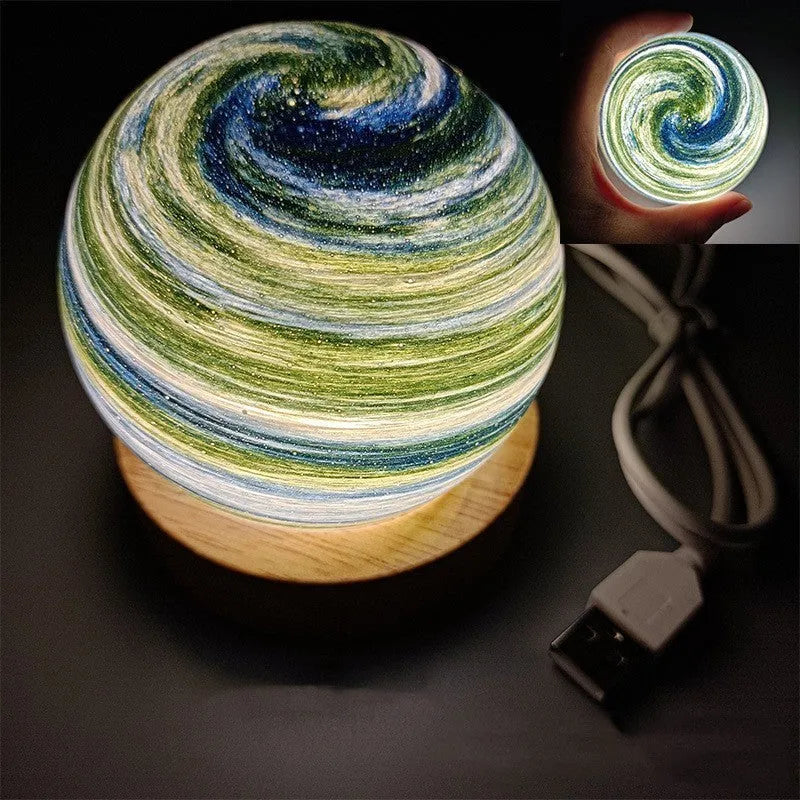 Planets themed USB night light with modern design and three-colour dimming on bedside table.